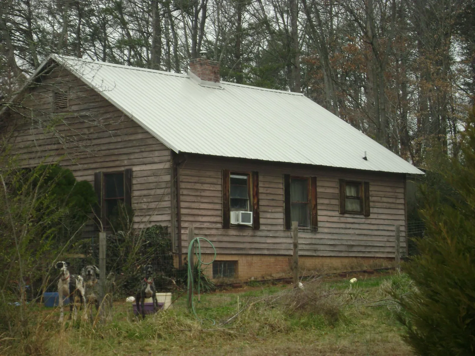 White metal roof on an old wood sided farmhouse, from a Asphalt Shingle Roof Repair job in Tonganoxie